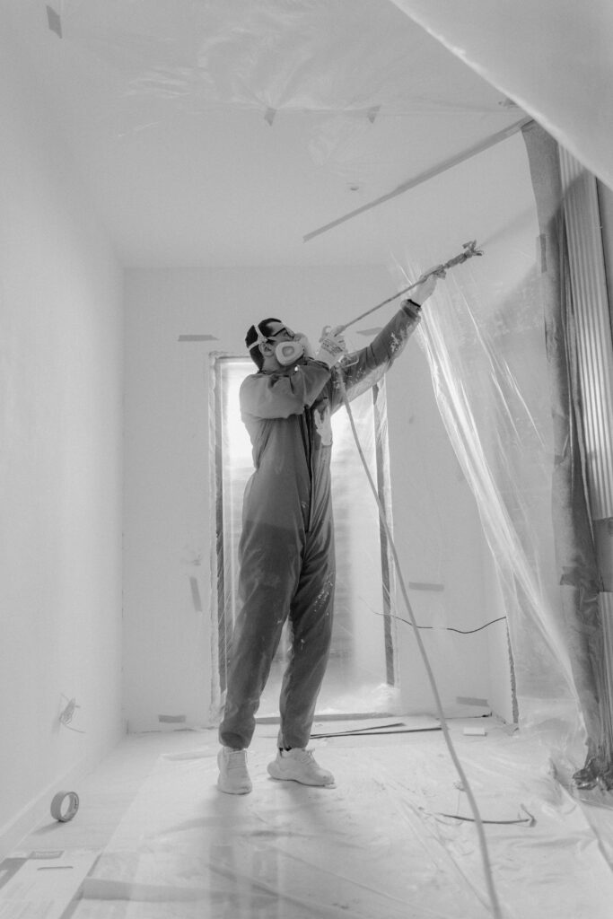 Black and White Photo of a Man Working at a Construction Site